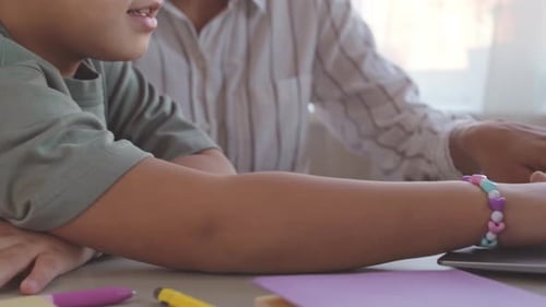 Child and Adult Working Together on Laptop at Home