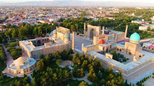 Ancient Museum And Madrasahs In Registan During Sunset In City Of Samarkand, Uzbekistan. - aerial