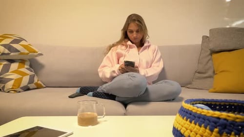 Young Woman Relaxing at Home on Couch