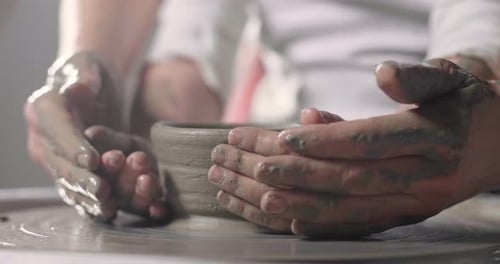 Hands Molding Clay on a Pottery Wheel