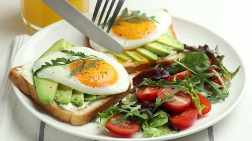 Delicious Avocado Toast with Fried Eggs and Salad