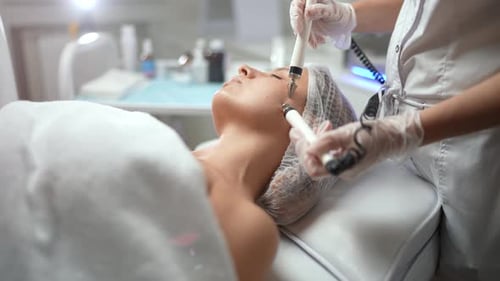 Woman Receiving Innovative Facial Treatment in Clinic
