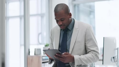 Smiling Man Using Tablet in Modern Office