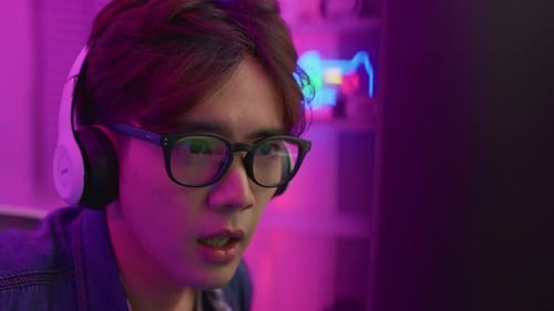 Young Adult Gamer Focused on Intense Video Game