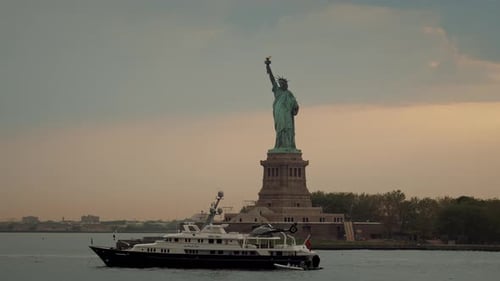 The view of the Status of Liberty from the New York harbor at sunset