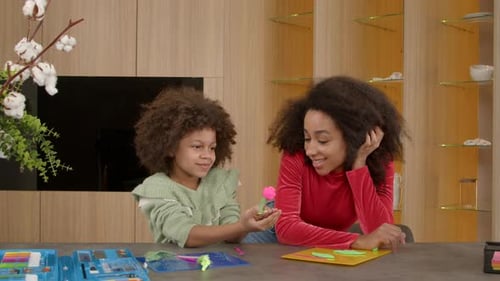 Girl Shows Woman Clay Flower She Made