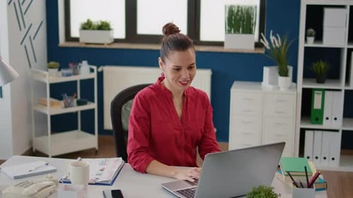 Office Worker Planning Research Data Strategy on Laptop