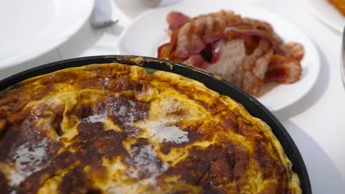 close up panoramic view of perfect breakfast with beacon, omlet and toasted garlic bread
