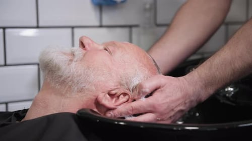 Man Getting Hair Shampooed at Barbershop