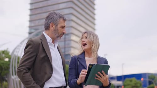 Professional Business Partners Using a Tablet Outdoors in the City