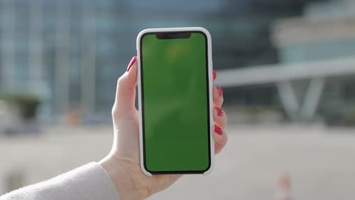 Woman Hands with Green Screen Display on Outside