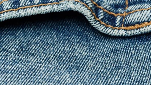Close Up of Blue Denim Fabric and Stitching
