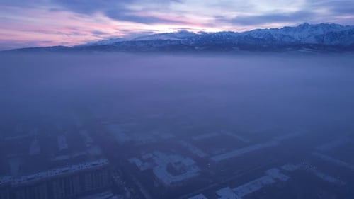 Dawn Over the City in Fog and Smog