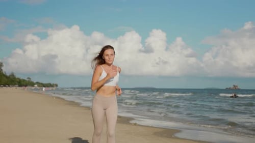 Woman Running on Tropical Beach on Sunny Day