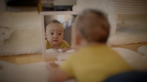 Happy Infant Smiling at Self in Mirror
