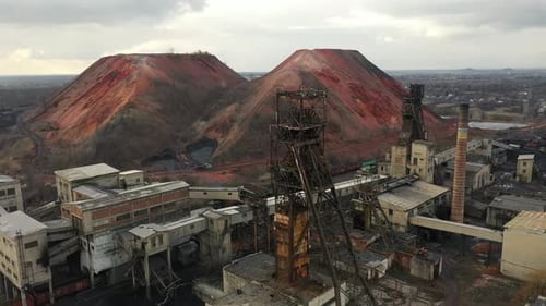Old Coal Mine Elevator and Slag Heaps on a Cloudy Day Vintage Coal Mining Shaft Building Weathered
