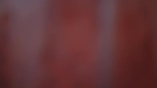 Young Woman Exploring Between Metal Columns in City