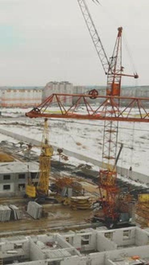 Construction Cranes with Raised Booms on Unfinished Project