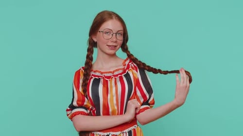 Smiling Teen with Braids Poses on Blue Background