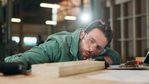 Man, carpenter and blow sawdust in workshop for cleaning, design or PPE for safety