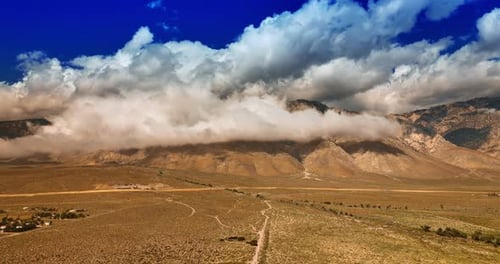 Desert Landscape with Mountains and Clouds Aerial Shot