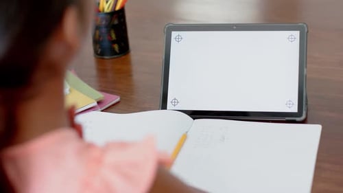 girl having elementary school class on tablet with copy space on screen, slow motion