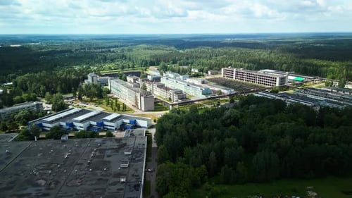 Industrial Complex Surrounded By Green Forests Drone Footage Showing Factories Among Lush Landscapes