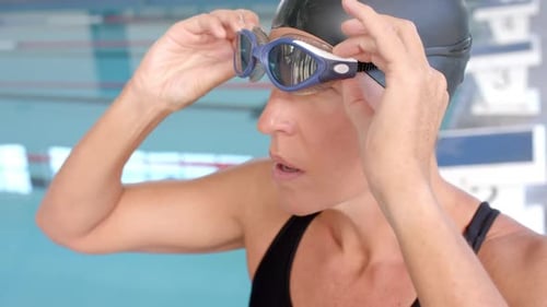 Swimmer Adjusting Goggles Before Swim in Swimming Pool