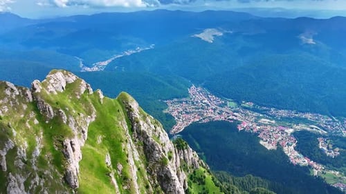 Aerial view of Bucegi Mountains and mountain town.