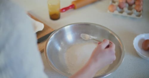 Close Up of Woman Adding Baking Powder or Yeast