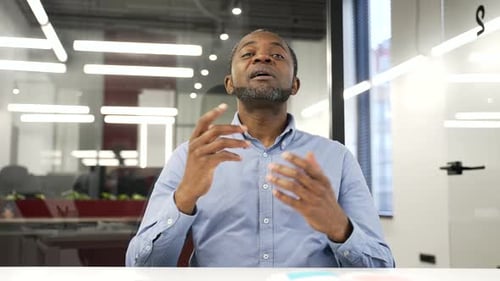 Webcam view. Confident african american businessman talking on a video conference call looking