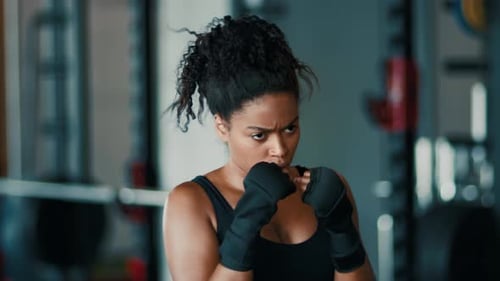 Woman Practicing Boxing Skills in a Gym During a Training Session