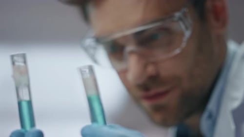 Biotechnology Expert Checking Experiment Result in Test Tubes Laboratory Closeup