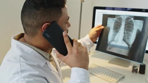 Medical Professional Reviews X-Ray During Phone Consultation