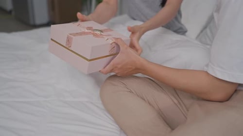Asian beautiful woman receive birthday present gift box from boyfriend.