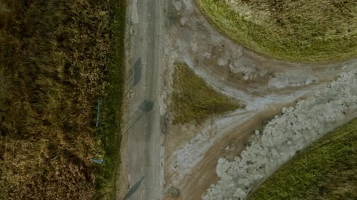 Downhill direction triangular intersection, narrow asphalt streets outside the city, aerial footage