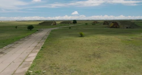 Abandoned Shiraki soviet military airbase with hangars and runway.