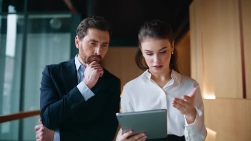 Two Partners Looking Tablet Walking Office Hallway Closeup Excited Colleagues