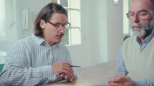 Young Adult and Senior Discuss Finances