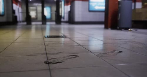 Footprints on the Tiled Floor of a Subway Station in a Busy Urban Area