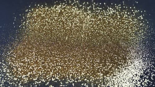 Gold dust falls on a black background