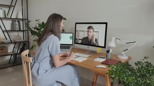 Woman Attends Video Conference at Home Office