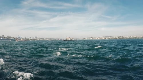 Serene Bosporus Strait with ferry and Istanbul skyline in the background