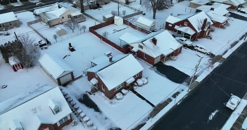 Red brick single story homes in small town in USA during winter snow. Rooftop view. Christmas holida