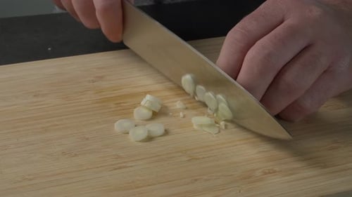 Scallions Sliced on Wooden Cutting Board in Kitchen
