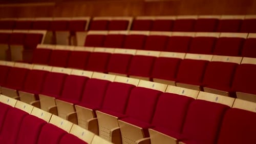 big empty concert hall with red seats in italy before the concert starts