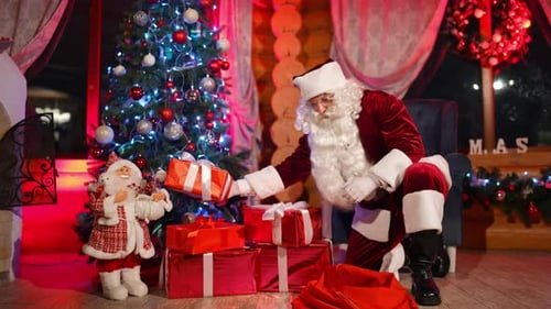 Santa Claus Arranging Christmas Presents by the Tree