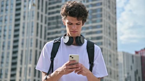 Young Adult Using Smartphone in the City