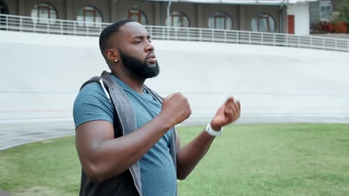Man Stretching Arms at Outdoor Urban Training Facility