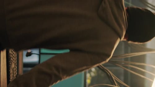 Young Adult Coding at Computers in Dark Room